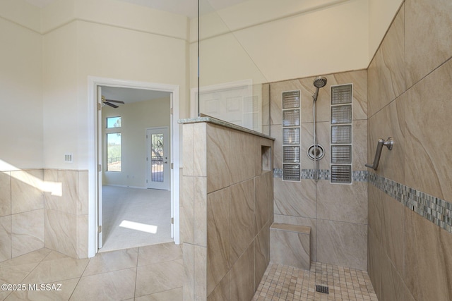 bathroom with tile patterned flooring and tiled shower