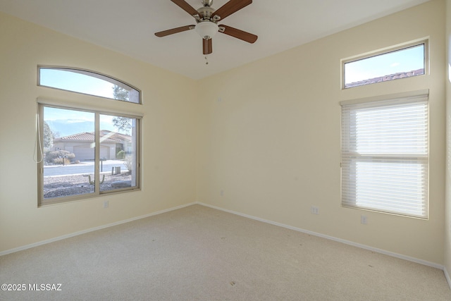 unfurnished room with ceiling fan and light colored carpet