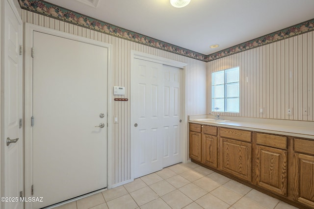 interior space featuring tile patterned flooring and sink