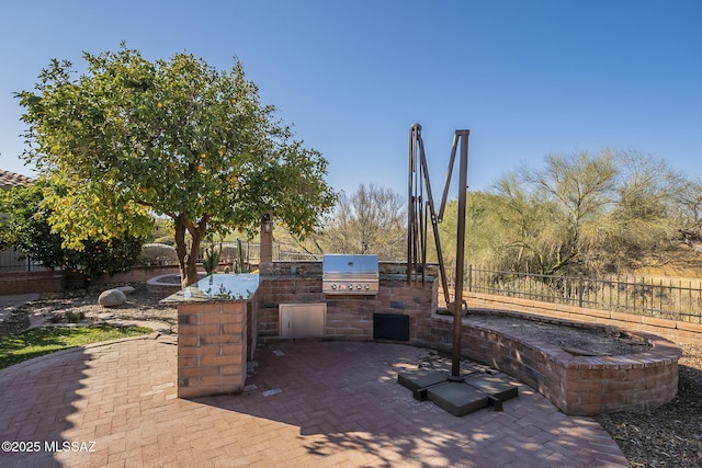 view of patio / terrace featuring area for grilling and a grill