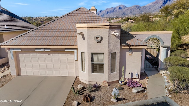 view of front facade featuring a garage and a mountain view