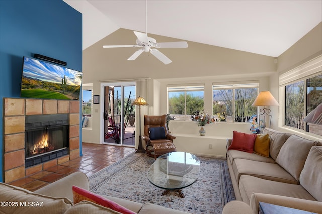 living room with tile patterned flooring, ceiling fan, high vaulted ceiling, and a fireplace