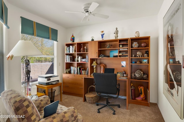 office featuring ceiling fan and light carpet