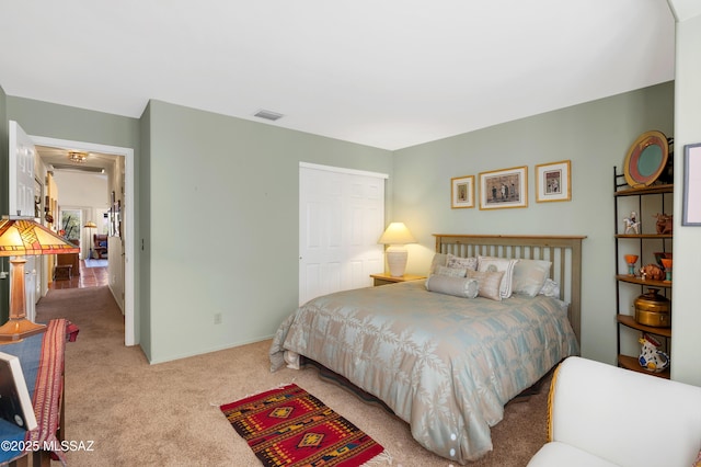 bedroom featuring light colored carpet and a closet