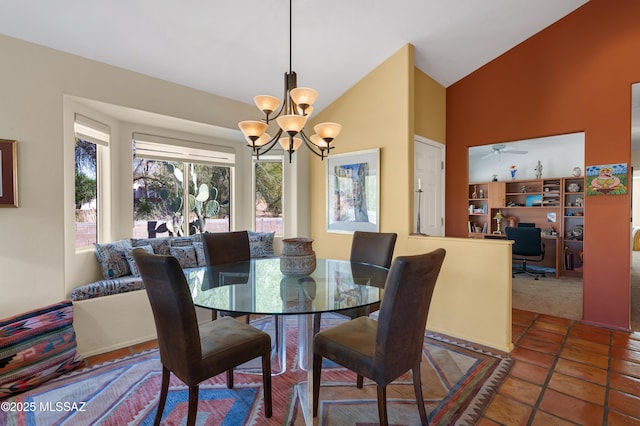 dining room featuring an inviting chandelier, lofted ceiling, and tile patterned flooring