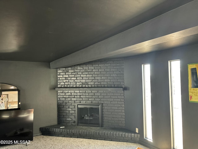 carpeted living room with a fireplace