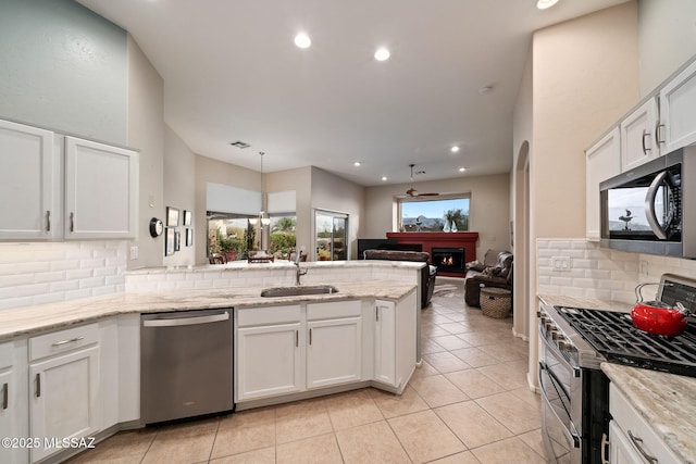 kitchen featuring white cabinetry, sink, kitchen peninsula, and appliances with stainless steel finishes