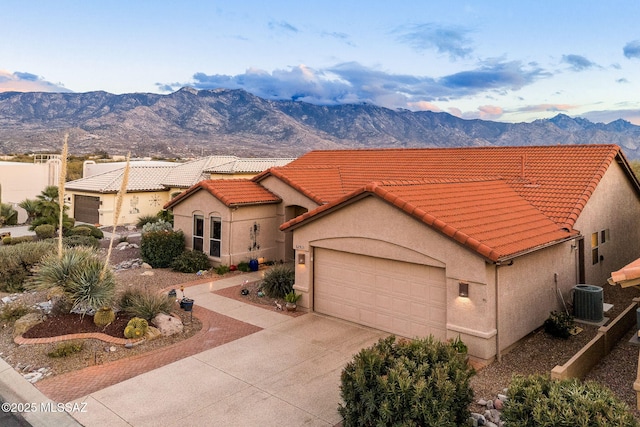 mediterranean / spanish-style house featuring cooling unit, a mountain view, and a garage