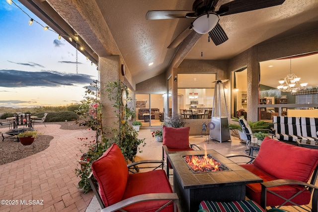 patio terrace at dusk featuring an outdoor fire pit