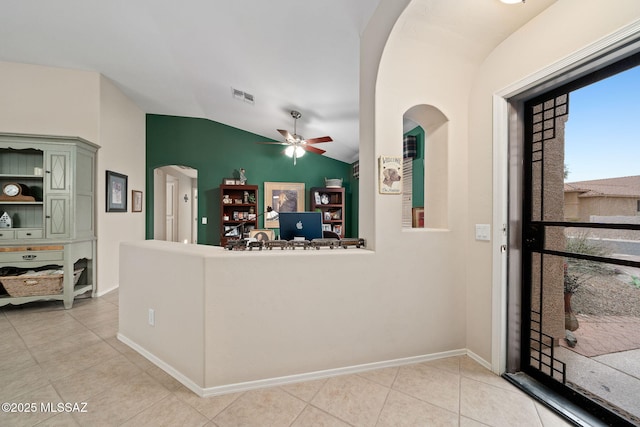 interior space with lofted ceiling, light tile patterned floors, ceiling fan, and green cabinets