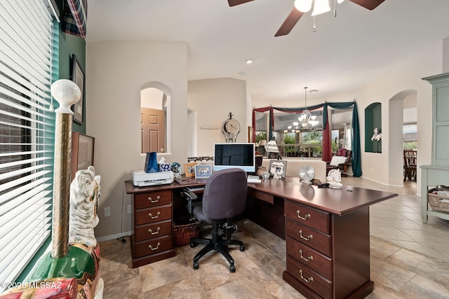 office area with ceiling fan with notable chandelier and vaulted ceiling