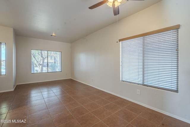 tiled empty room featuring ceiling fan