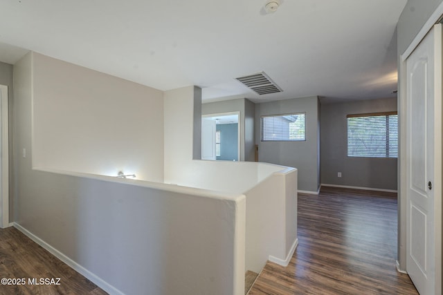 corridor featuring dark hardwood / wood-style flooring