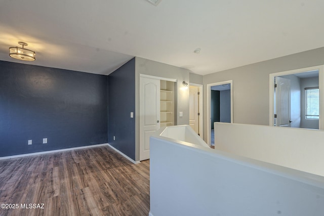 interior space featuring built in features and dark hardwood / wood-style flooring