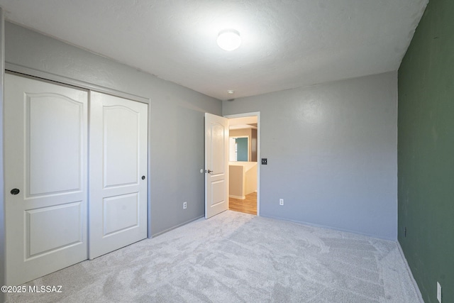 bedroom with a closet and light carpet