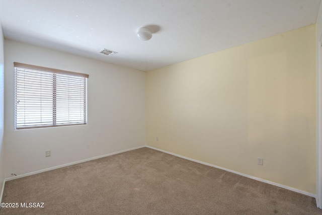 empty room featuring light colored carpet