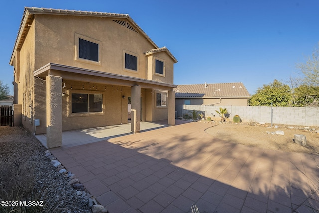 back of house with a patio area