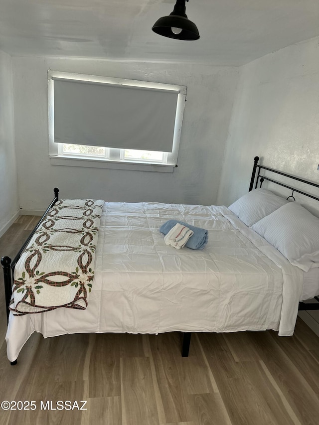 bedroom with wood-type flooring