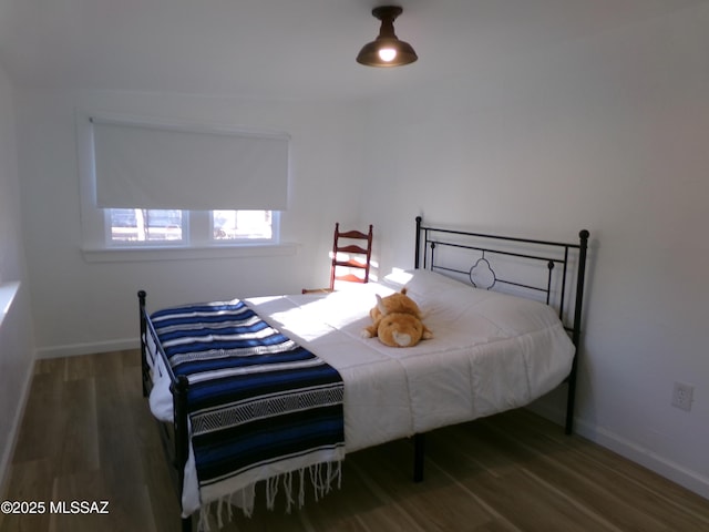 bedroom featuring dark hardwood / wood-style flooring