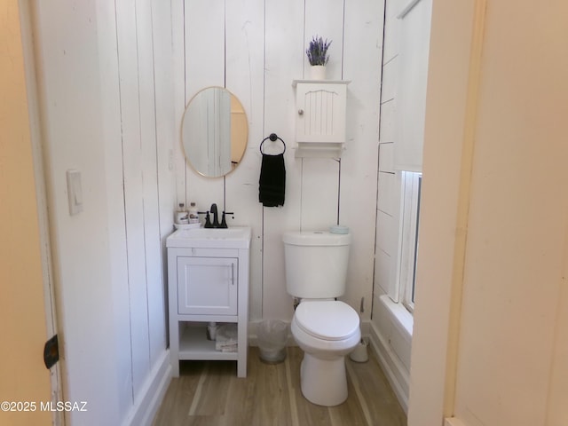 bathroom with vanity, hardwood / wood-style floors, and toilet