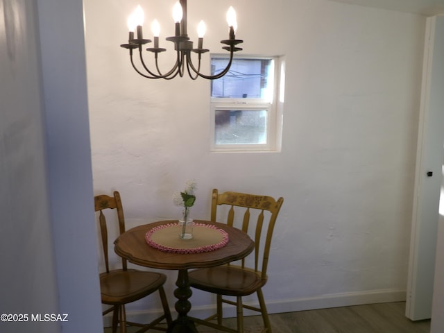 dining room featuring an inviting chandelier and dark wood-type flooring