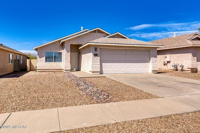 ranch-style home with stucco siding, driveway, a garage, and fence