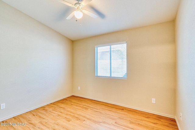 unfurnished room with baseboards, light wood-style flooring, and a ceiling fan