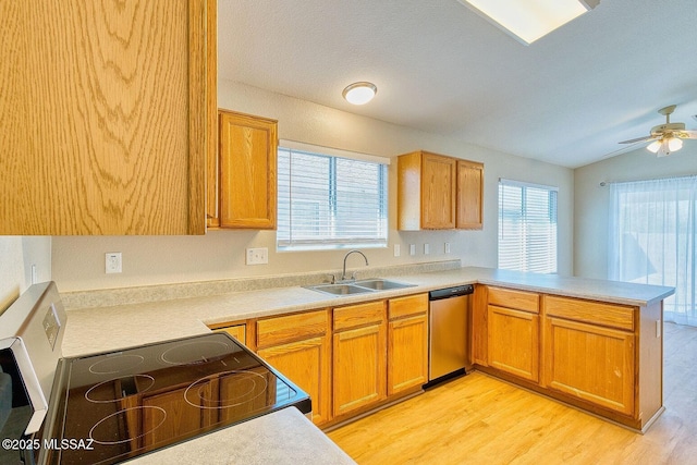 kitchen with a sink, light countertops, a peninsula, electric range, and stainless steel dishwasher