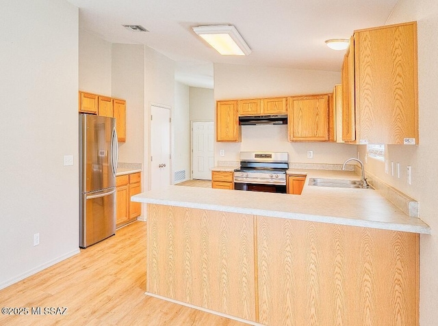 kitchen featuring visible vents, light countertops, a peninsula, stainless steel appliances, and a sink