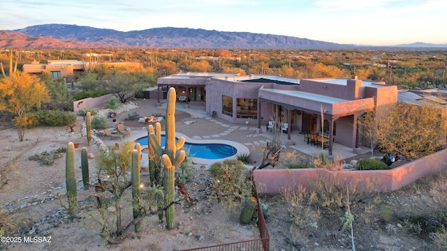 view of swimming pool with a mountain view and a patio