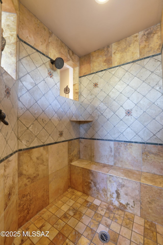 bathroom with tiled shower