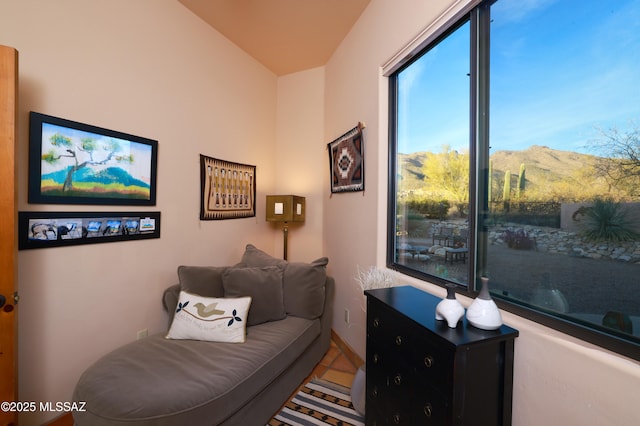 sitting room featuring a mountain view and tile patterned floors