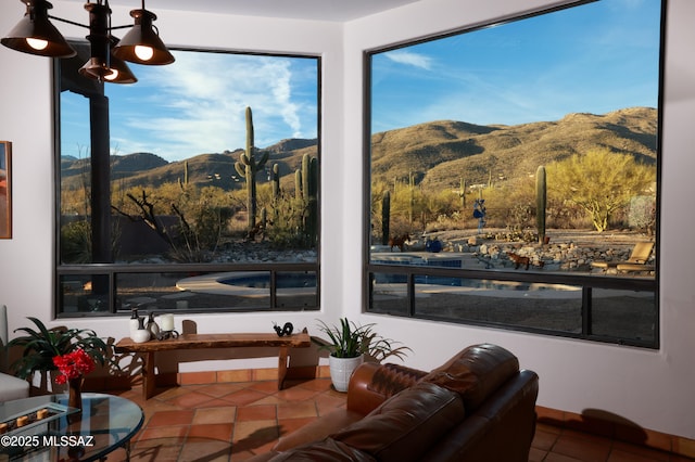 interior space featuring an inviting chandelier, a mountain view, and tile patterned floors