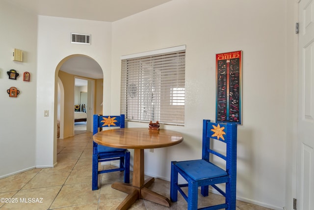 dining area featuring light tile patterned flooring