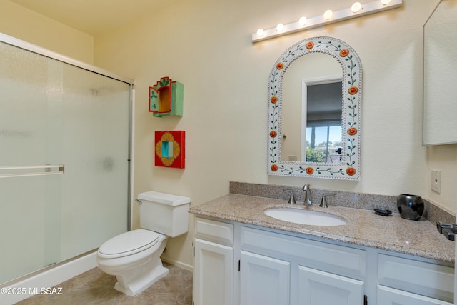 bathroom featuring tile patterned floors, vanity, toilet, and a shower with shower door