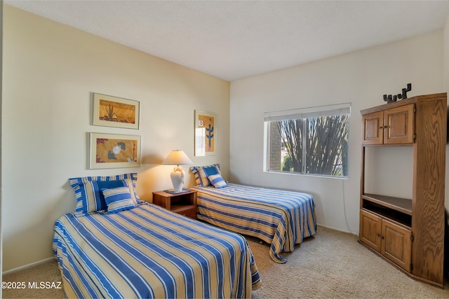 bedroom featuring light carpet