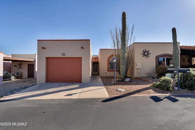 pueblo-style house featuring a garage