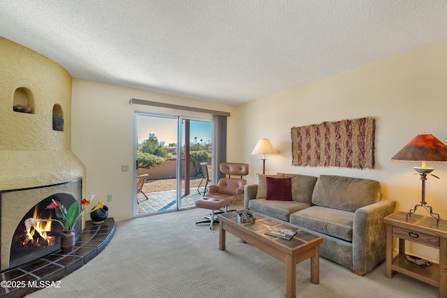 living room featuring a fireplace, a textured ceiling, and carpet