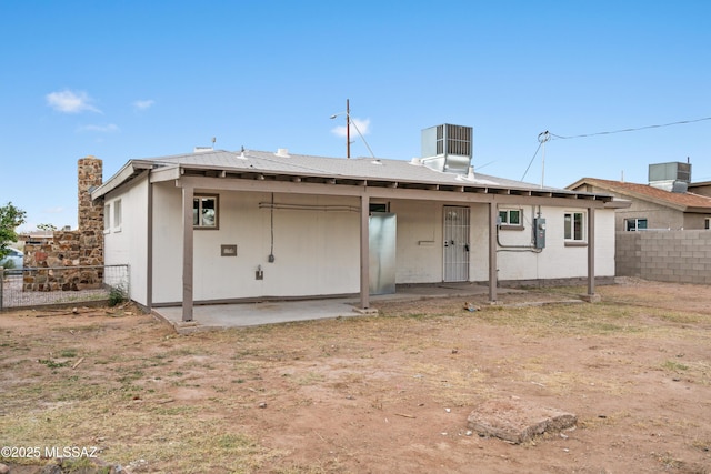 rear view of property featuring cooling unit and a patio area