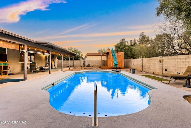 pool at dusk featuring a patio