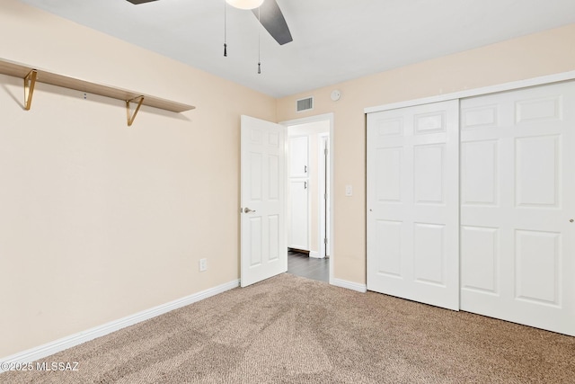 unfurnished bedroom featuring carpet floors, a closet, and ceiling fan