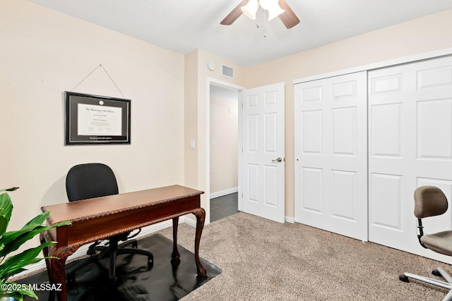 carpeted office with ceiling fan