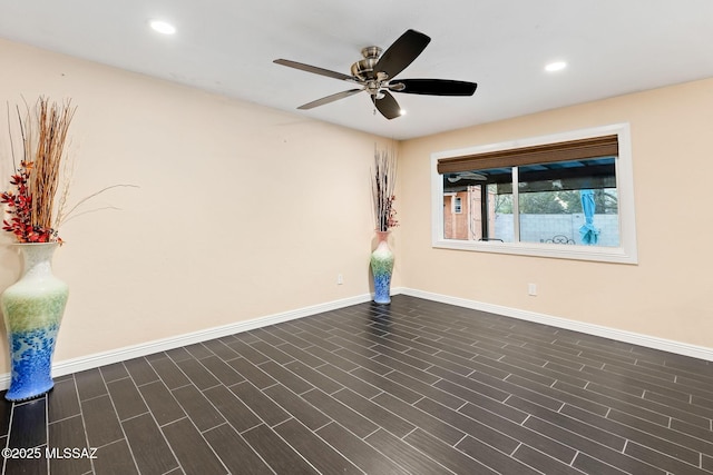 empty room featuring dark hardwood / wood-style flooring and ceiling fan