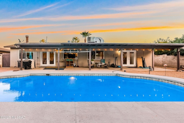 view of pool with a patio area and french doors