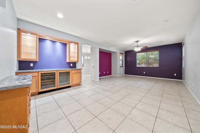 interior space featuring wine cooler, light tile patterned floors, and ceiling fan