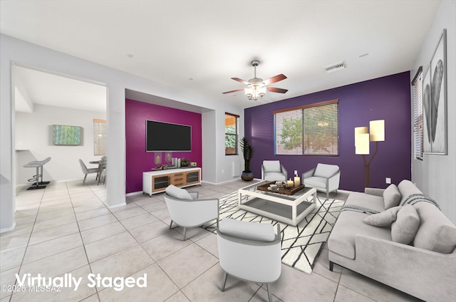 tiled living room with ceiling fan
