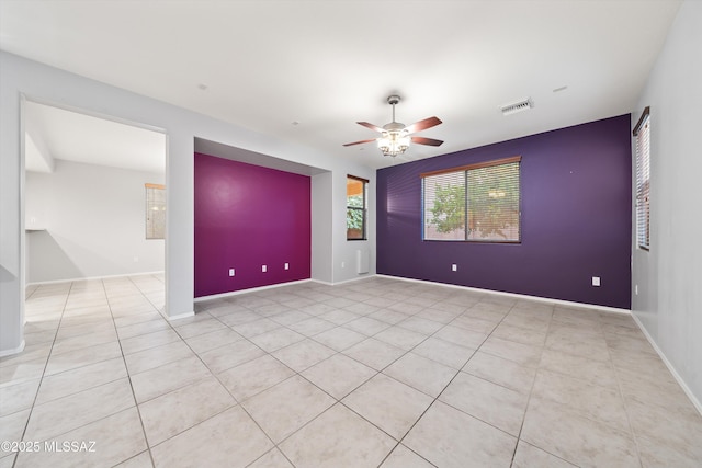 unfurnished room featuring light tile patterned flooring and ceiling fan
