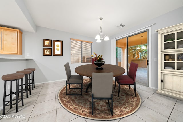 dining space featuring an inviting chandelier and light tile patterned flooring