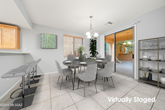 dining area with an inviting chandelier, light tile patterned floors, and a healthy amount of sunlight