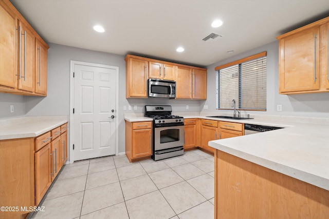 kitchen with light tile patterned flooring, appliances with stainless steel finishes, and sink